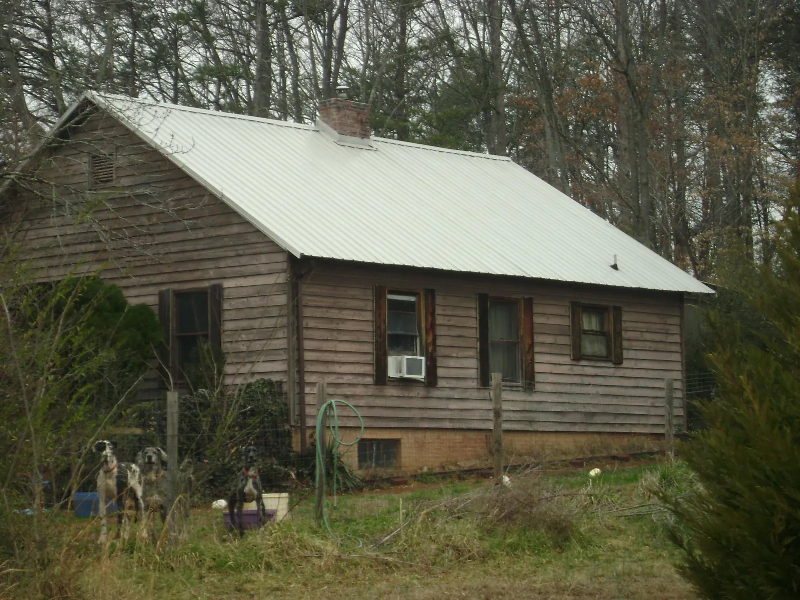 White metal roof on an old wood sided farmhouse, from a Metal Roof Installation job in Mc Cormick